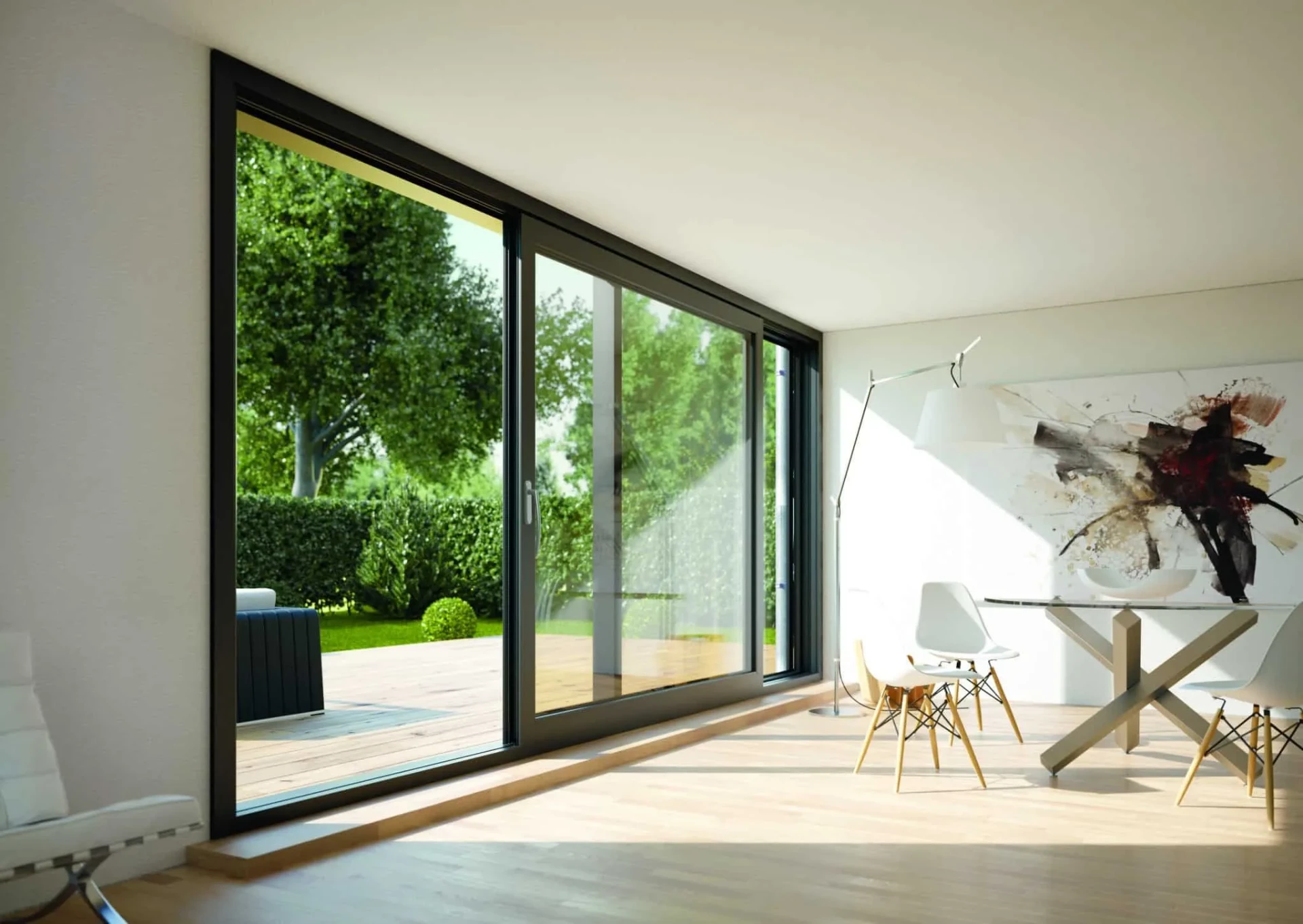 Large black frame sliding glass door opening a modern dining room to a garden terrace